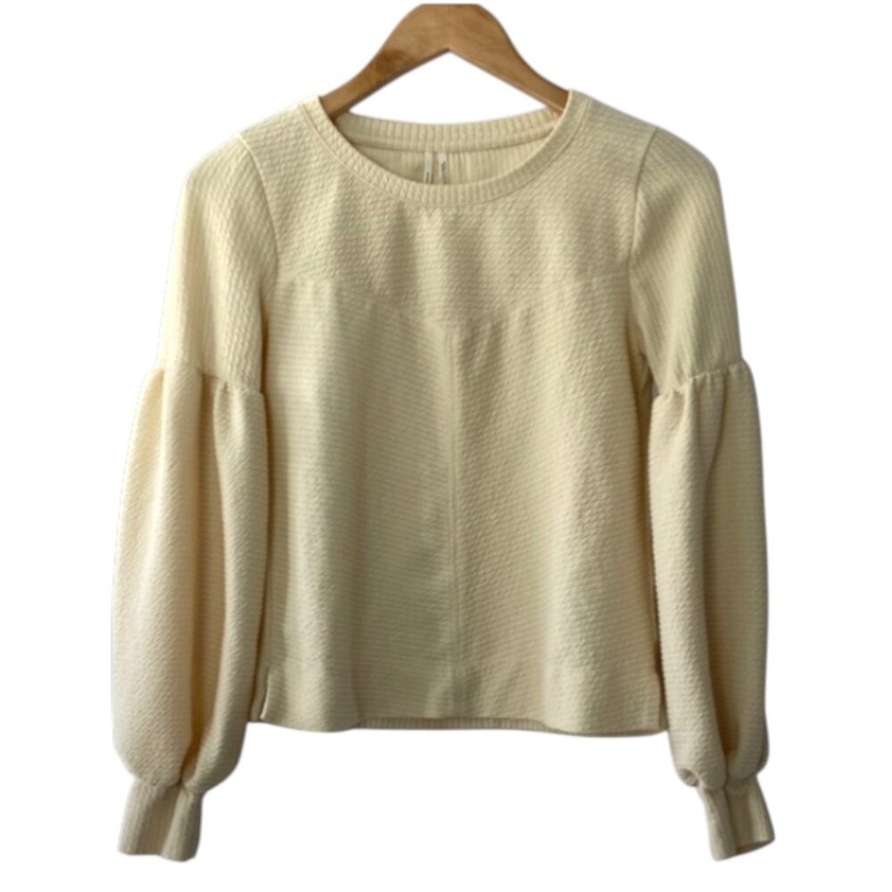 By Anthropologie Bayleigh Cropped Top in cream with balloon sleeves.